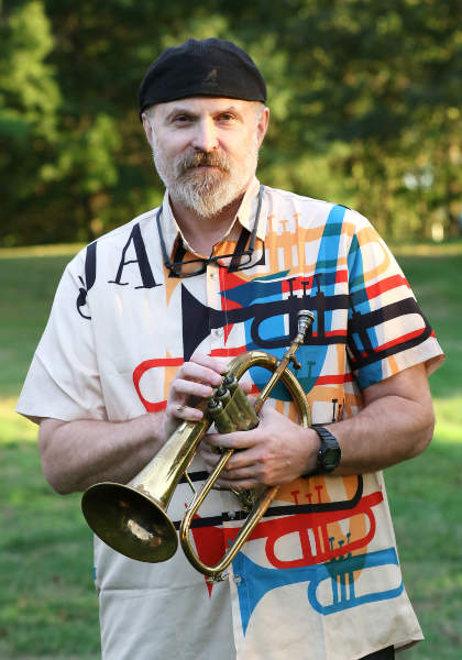 Jon Leonard outdoors holding a flugelhorn